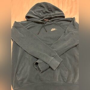Blue/teal Nike sweatshirt tiny rip at the bottom right of the sweatshirt.